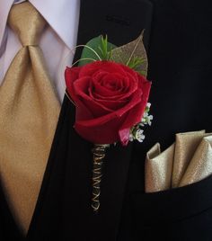 a boutonniere with a red rose and baby's breath attached to it