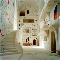 an artisticly decorated hallway with stairs leading to the second floor and drawing on the walls