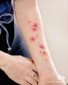 a woman's arm with flowers on it