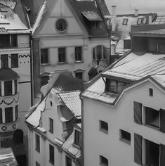 black and white photograph of buildings with snow on them