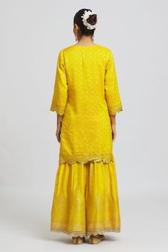 Mustard yellow midi length silk kurta with all over jaal bootas. Paired with a banarasi silk flared gharara with zari pearl gold lace and organza silk dupatta with all over sequin and embriodery.
Components: 3
Pattern: Embroidered
Type Of Work: Sequin
Neckline: Round
Sleeve Type: Three-quarter
Fabric: Banarasi Silk
Color: Yellow
Occasion: Mehendi and Haldi - Aza Fashions Eid Yellow Palazzo Set With Self Design, Yellow Self Design Palazzo Set For Diwali, Yellow Self-design Palazzo Set For Wedding, Diwali Yellow Self Design Palazzo Set, Yellow Silk Dress For Diwali, Festive Yellow Sharara With Self Design, Yellow Unstitched Sharara With Self Design, Yellow Chikankari Embroidery Sharara In Art Silk, Yellow Art Silk Sharara With Chikankari Embroidery