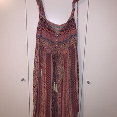 This Dress Is A Size Medium From Hollister And The Straps Are Adjustable Spaghetti Straps As Well As Straps That Go Over The Shoulder And It Has Some Waviness To The Sleeve. On The Top Front, There Are Buttons That Go Down Where The Chest Is So They Can Be Adjusted. There Are Colors Such As Blue, Pink, Burgundy, Beige, And Many More Colors That Are Designed In A Variety Of Patterns Including Some Tribal Patterns. There Is Also A Big Tie That Has Fringes At The End And It Ties In The Back. Nwt. Pink V-neck Boho Sundress, Bohemian Pink Sleeveless Sundress, Pink Bohemian Sleeveless Sundress, Flowy Pink Maxi Dress With Spaghetti Straps, Pink Sleeveless Maxi Dress Beach Cover-up, Pink Spaghetti Strap Maxi Dress For Vacation, Bohemian Pink Sundress With Spaghetti Straps, Pink Bohemian Sundress With Spaghetti Straps, Pink Maxi Dress With Spaghetti Straps For Beach