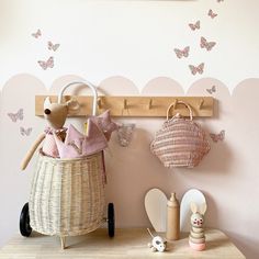 there is a stuffed animal sitting in a basket on the shelf next to a wall