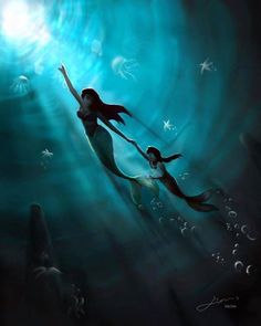 an image of two mermaids swimming in the water