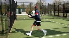 a man running across a tennis court holding a racquet