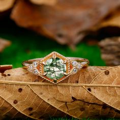 a ring sitting on top of a leaf in the grass