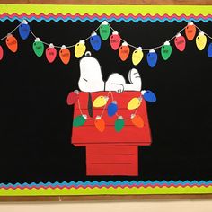 a bulletin board decorated with christmas lights and snoopy dogs sitting on top of a red car