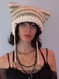 a woman wearing a crocheted hat with beads