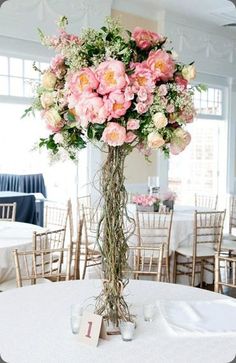 the centerpieces are adorned with flowers and greenery