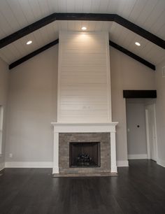 an empty living room with a fireplace in it