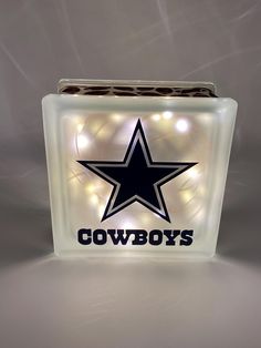 a light up box with the word cowboys on it and a star in the center