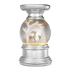 a snow globe with a deer and tree inside