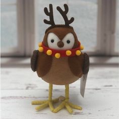 a stuffed owl with antlers on its head