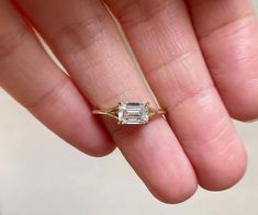 Emerald Cut Minimalist Moissanite Engagement Ring, Solitaire Split Shank Moissanite Ring, Daily Wear Ring, Gift For Her, 14K Solid Gold Ring Item Description: Stone - Moissanite & Simulated Diamond Shape-  Emerald Cut  1. White Gold: 10K/14K/18K 2. Yellow Gold: 10K/14K/18K 3. Rose Gold: 10K/14K/18K 4. Silver: Sterling Silver 925 Size Customization: What Size you want... * You can also Customize ring size in US 4 to US 12! It sometimes affects to price. * Main Stone & Shape Customization: Main Stone: Cubic Zirconia, Moissanite, Natural Diamond, CVD Diamond Shape Choice: Round Cut, Heart, Princess Cut, Pear Cut, Cushion Cut, Marquise, Oval Shape, Asscher, Emerald, Radiant, Old European Cut, Old Mine Cut * Check out Special Notes: At checkout, leave us a note in the message box for the Ring s Minimalist Emerald Ring, Emerald Silver Engagement Ring, Split Engagement Ring, Ring Daily Wear, Engagement Ring Solitaire, Ring Inspo, Moissanite Engagement Ring Solitaire, Cvd Diamond, Solid Gold Ring