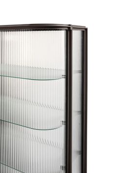 a glass display case with three shelves on the front and one shelf below it, against a white background