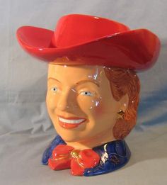 a ceramic head of a man wearing a red hat