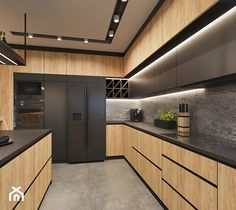 a modern kitchen with black counter tops and wooden cabinetry, along with an island