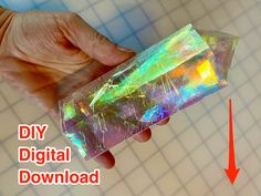 a person is holding a crystal object with an arrow pointing to it and the text diy digital download below