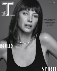 a woman with bangs on the cover of t magazine, wearing a black tank top