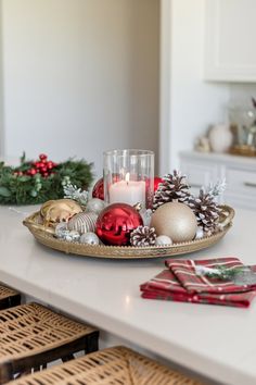 a tray with christmas decorations and candles on it