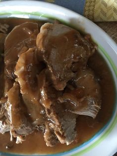 a white plate topped with meat and gravy