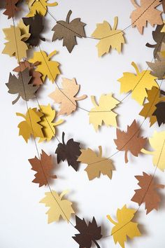 some brown and yellow leaves hanging from a string