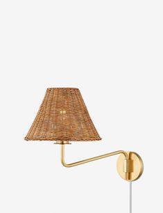 a lamp that is on the wall next to a light fixture with a wicker shade