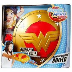 the dc super hero girls wonder woman shield is shown in its packaging, and it's gold