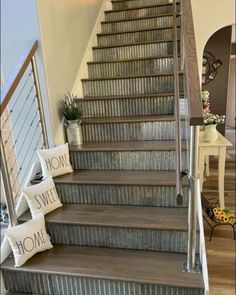 a set of stairs with some signs on it and two pillows sitting next to each other