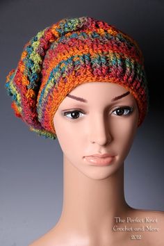 a mannequin head wearing a multicolored knitted hat