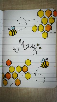 an open notebook with bees and honeycombs written in cursive writing on lined paper