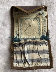 an old piece of cloth with some stitching on it and a clock in the middle