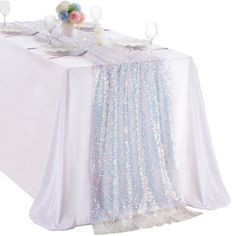 the table is set with white and blue sequins