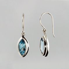 These beautiful 925 silver earrings were handmade in a small family manufactory where the craft of the silversmith and its tradition was passed down from generation to generation. The blue topaz gemstones are of natural origin, not synthetically produced stones! The shade is Sky Blue (sky blue). They have a size of 6 x 12 mm. The earrings including the ear hooks have a length of approx. 30 mm. To protect against losing the earrings you get a pair of silicone stoppers for free. Also included in d Blue Topaz Earrings, The Ear, Topaz Earrings, Earrings Women, 925 Silver Earrings, Hanging Earrings, Topaz Gemstone, The Craft, Elegant Earrings