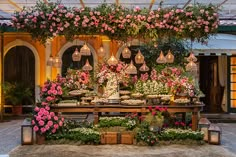 a table topped with lots of flowers and cakes