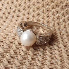 DESCRIPTION: Elegant sterling silver ring featuring a large freshwater white pearl and sparkling clear CZ stones. This timeless piece is perfect for engagements, weddings, or everyday wear. Ideal gift for her! BEST FEATURES: Adds a natural, timeless beauty. Durable and tarnish-resistant. Offers an affordable yet luxurious touch. Makes a bold, elegant statement. Ideal for special occasions or everyday elegance. OUR GUARANTEE "We stand by the quality of our jewelry! If you experience any issue wit Pearl Ring With Diamond Accents, White Diamond Ring With Pearl Drop For Anniversary, White Pearl Drop Ring For Anniversary, Silver Pearl Rings With Diamond Accents, White Pearl Rings With Diamond Accents, Silver Rings With Diamond Accents And Pearl, Silver Pearl Drop Ring, Silver Pearl Ring With Pearl Drop, Silver Pearl Ring With Diamond Accents As A Gift