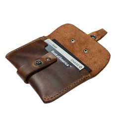 a brown leather wallet with a credit card holder in the front and an id slot on the back