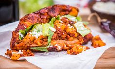 a pile of food sitting on top of a wooden cutting board