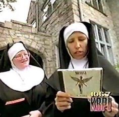 two women dressed in nun costumes reading a book