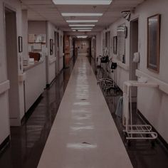 an empty hospital hallway with chairs and medical equipment