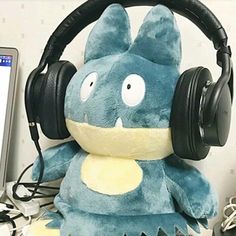 a stuffed animal with headphones on sitting in front of a computer