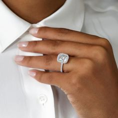 a close up of a person wearing a diamond ring