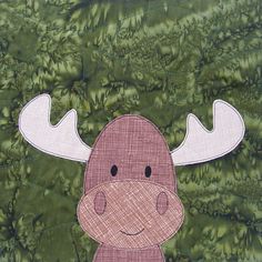 moose applique pattern on the front of a quilt