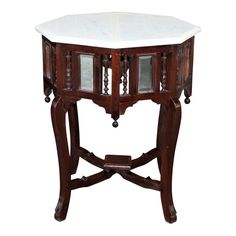 an ornate wooden table with marble top