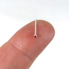 "A tiny Ruby Sterling Silver nose Stud. This nose stud is made of sterling silver so it is great for those with sensitive skin. The gem measures 1.5mm-very tiny The stud is made of 20g wire and is Bend to Fit, meaning you can bend it into an \"L\" shape to keep it in your nose. This listing is for one nose stud ( 1 piece)" Minimalist Sterling Silver Nose Studs Nickel Free, Minimalist Sterling Silver Nose Studs For Gifts, Hypoallergenic Sterling Silver Nose Studs As Gift, Dainty Tiny Nose Studs For Gift, Nose Piercing Stud Tiny Silver, Minimalist Silver Nose Studs, Hypoallergenic Sterling Silver Round Nose Studs, Hypoallergenic Sterling Silver Nose Studs, Hypoallergenic Sterling Silver Nose Stud