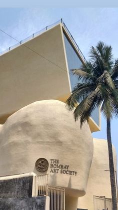 an art deco building with a palm tree next to it