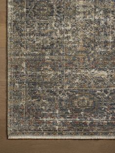 an area rug with various colors and patterns on the floor, including brown, blue, beige