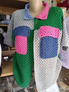 a crocheted shirt is displayed on a mannequin's dummy in a store