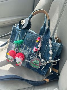 Marc Jacobs Tote Bag Accessories, Hello Kitty Claw Clip, Tote Bag With Charms, Junk Purse, Marc Jacobs Tote Bag Outfit, Tote Bag Keychain, Bag Charms Diy, The Tote Bag Marc Jacobs, Bag With Charms