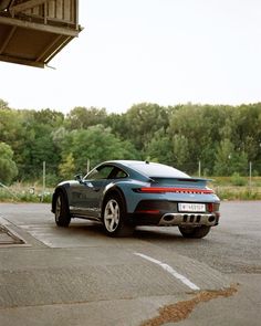 a blue sports car parked in a parking lot